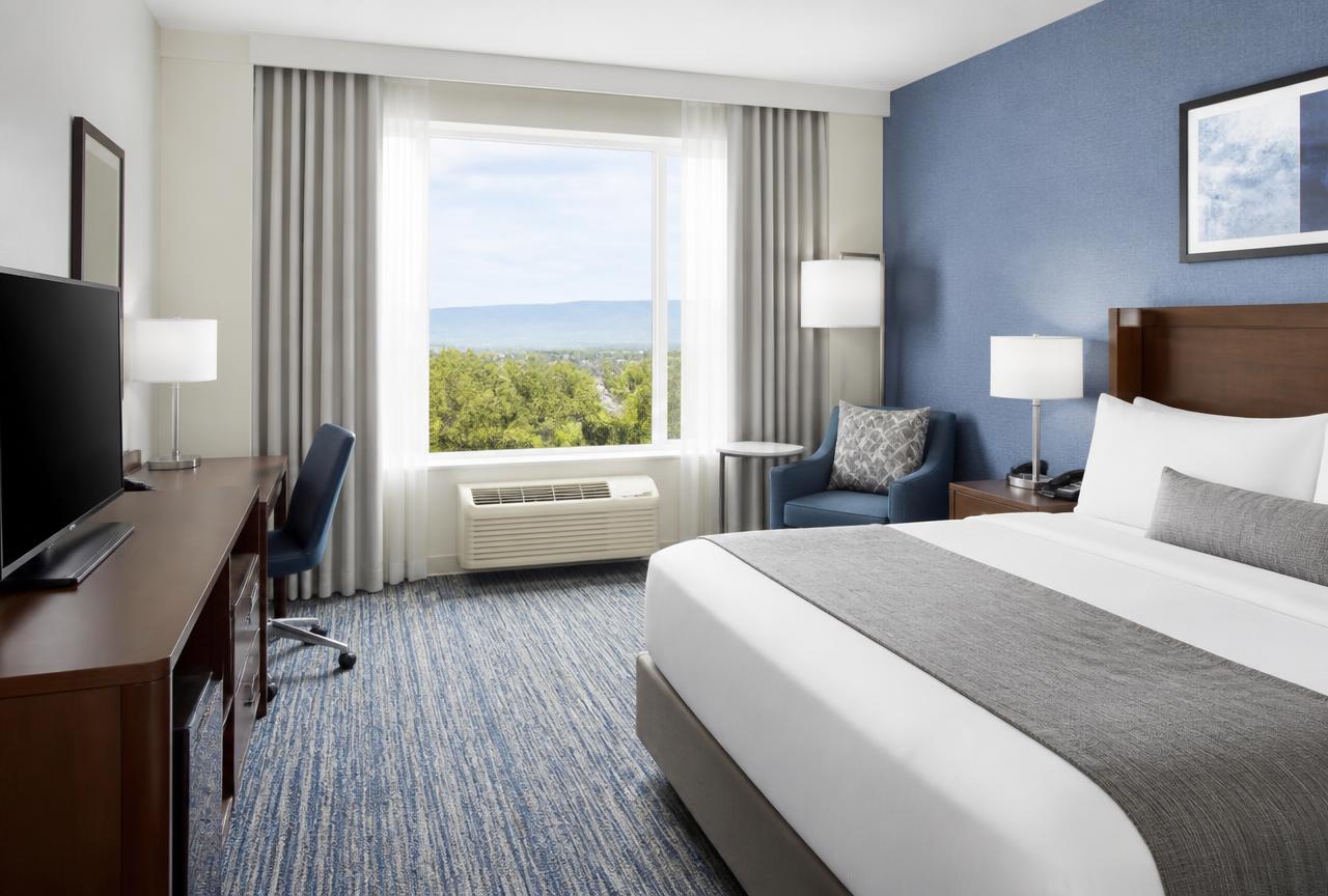 Hotel guest room with a through-wall PTAC unit beneath the window